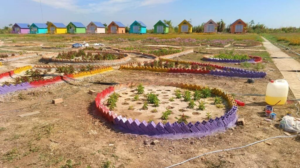 DIY star-shaped flower bed borders made from painted recycled bricks at Dream Garden